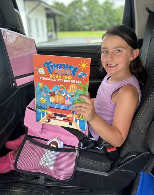 Child happily coloring in the Travel Time Road Trip Coloring and Activity Book during a car ride